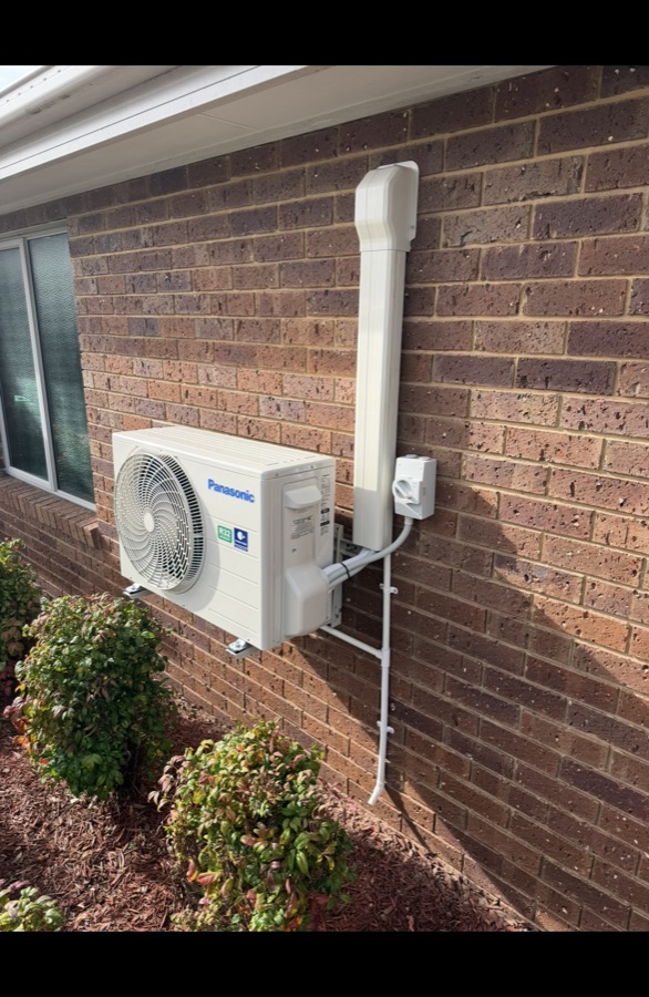 Panasonic split system air conditioner installed on brick wall