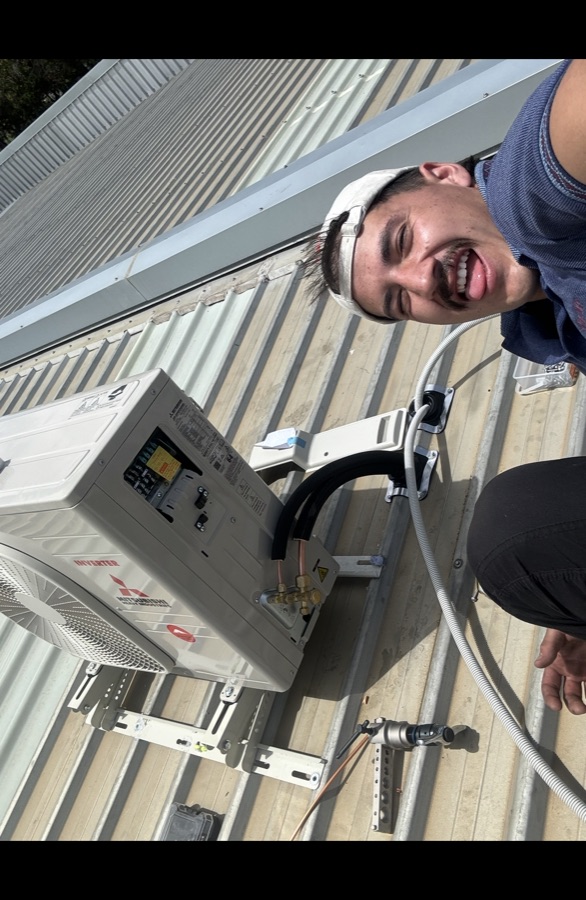 Split system air conditioning unit installed on roof