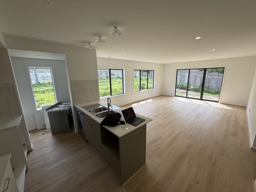 New build kitchen and living area with downlights and pendant lighting installed